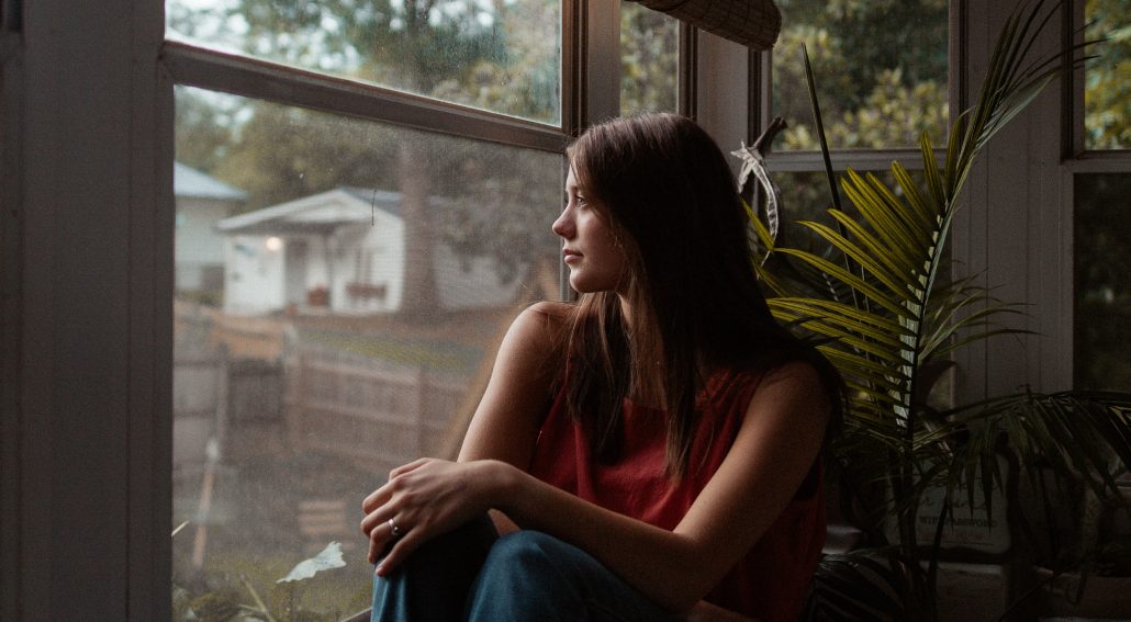 Woman sitting on a window