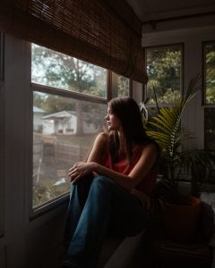 Woman sitting on a window