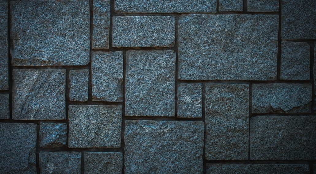A close up of a wall made of stone blocks