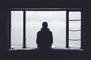 A man looking out through a window