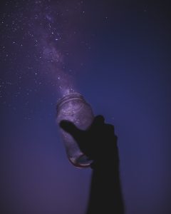 Person holding a glass jar
