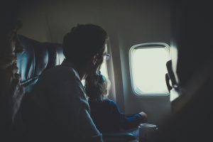 Dad and daughter sitting inside an airplane during daytime