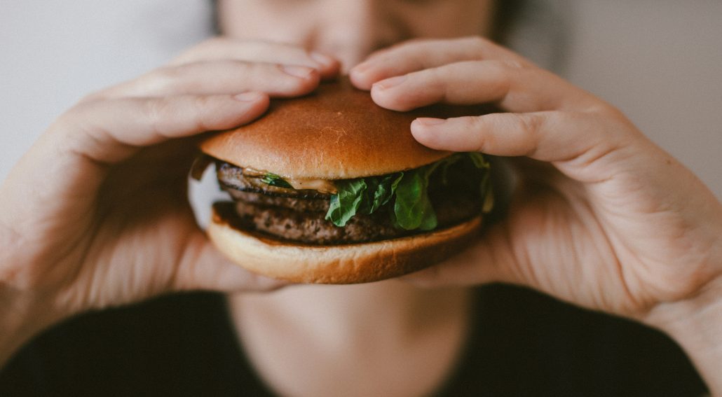 Person holding a burger