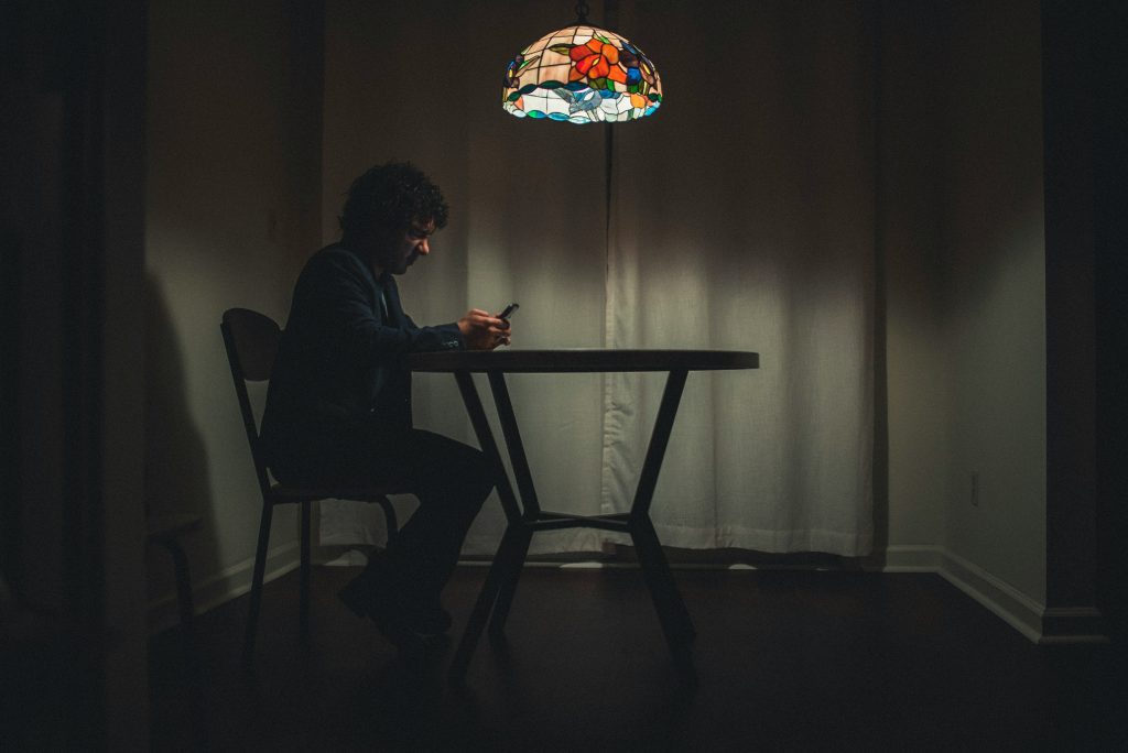 Man in black suit sitting on a chair