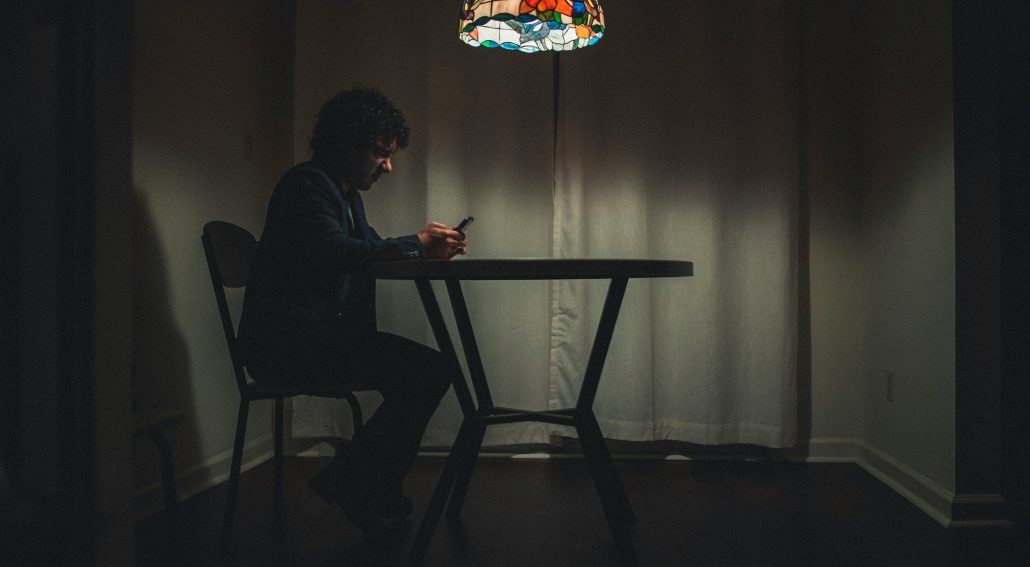 Man in black suit sitting on a chair