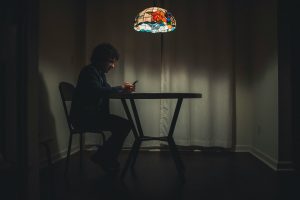 Man in black suit sitting on a chair