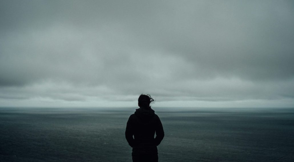 A person standing in front of an ocean