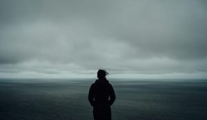 A person standing in front of an ocean