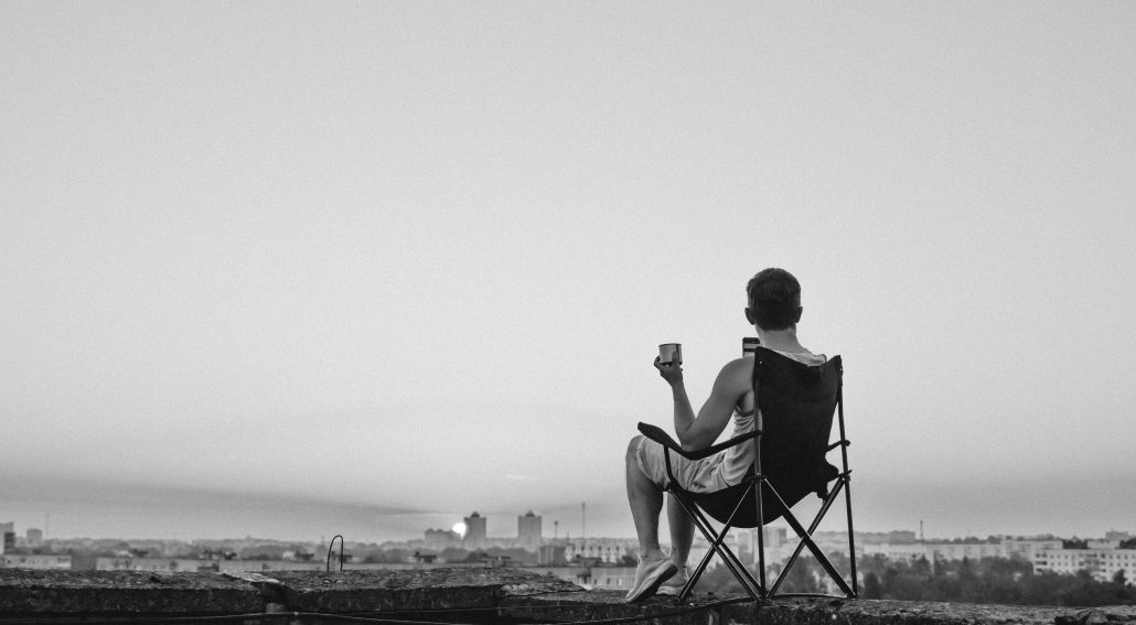 A man sitting in a chair on top of a roof | Matt Fox Coaching A man sitting in a chair on top of a roof