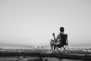 A man sitting in a chair on top of a roof