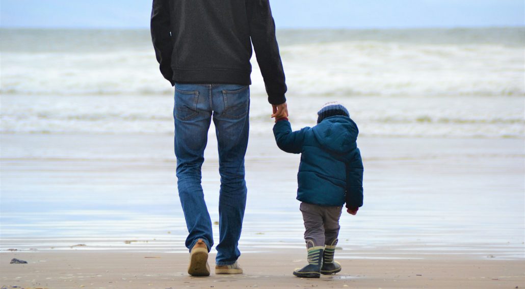Dad and son on a beach