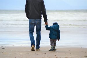 Dad and son on a beach