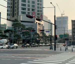 A city street filled with traffic and tall buildings
