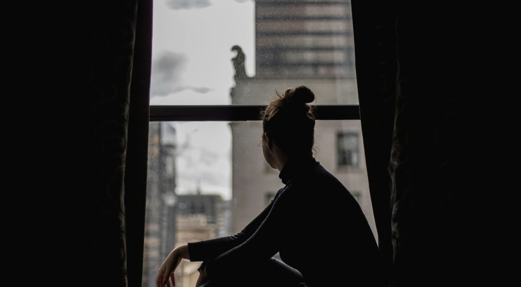 A girl looking out at an overlooking window