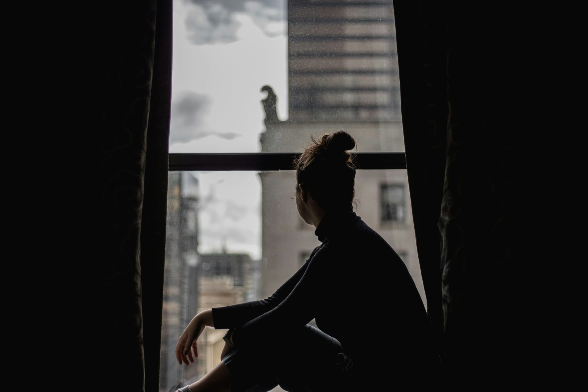 A girl looking out at an overlooking window