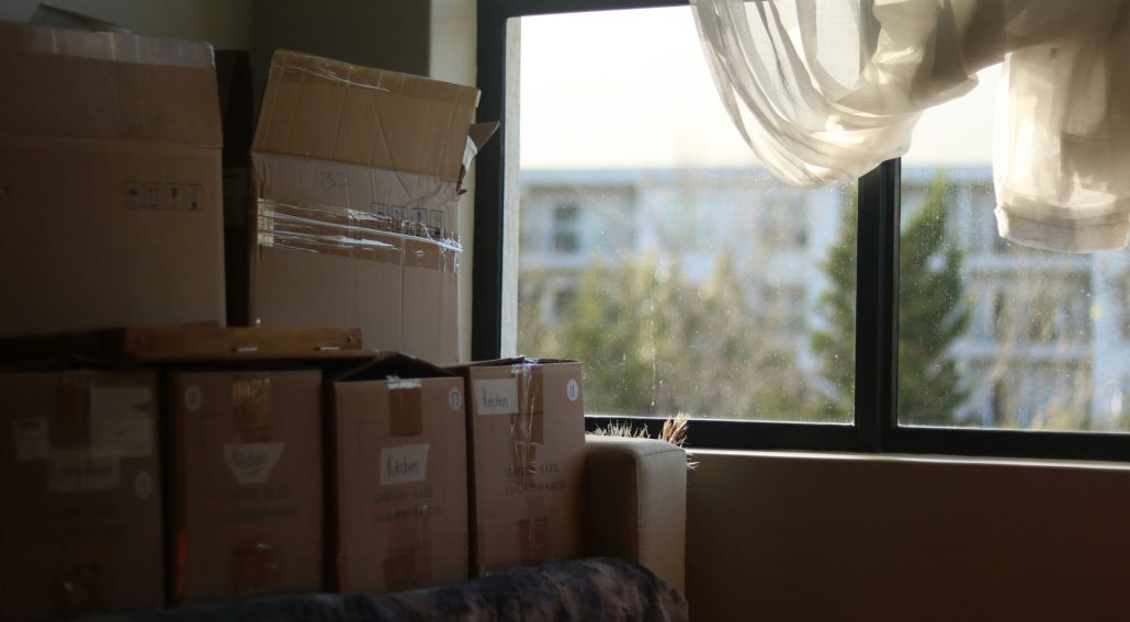 Stack of boxes beside a window with warm light coming in