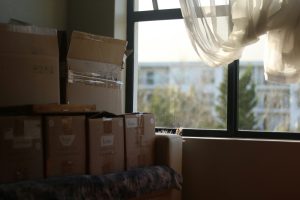 Stack of boxes beside a window with warm light coming in