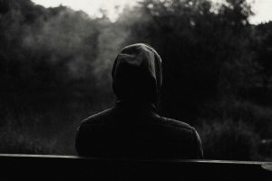 Silhouette of a man sitting on a bench