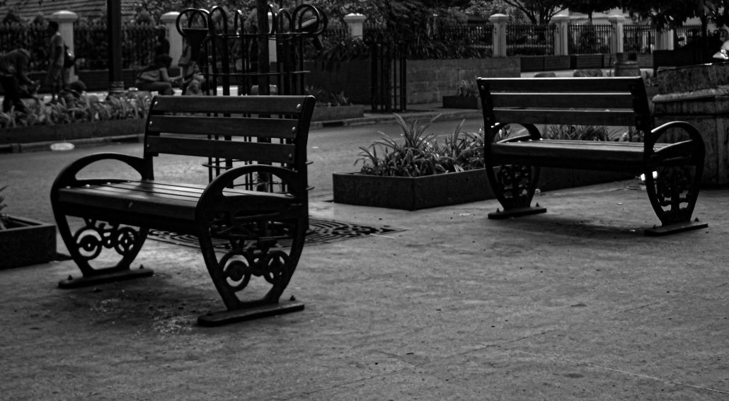 Two empty benches in a public park area