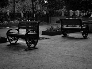 Two empty benches in a public park area