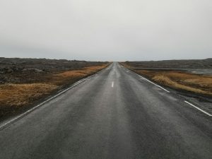 A long, empty road stretching into the distance on a cloudy day