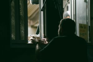 silhouette of a man in conversation at a service window