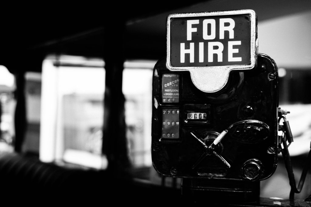 Grayscale photo of a for hire sign