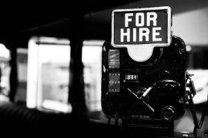 Grayscale photo of a for hire sign