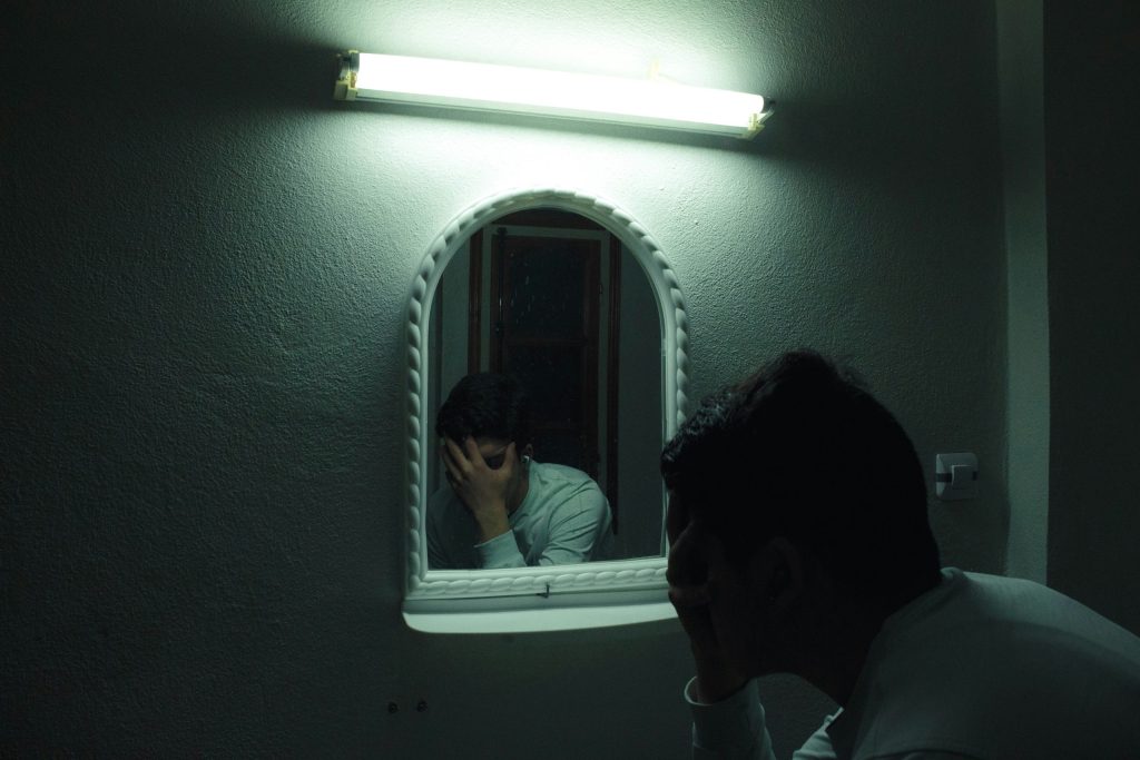 A man looking at himself in the mirror