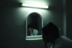 A man looking at himself in the mirror