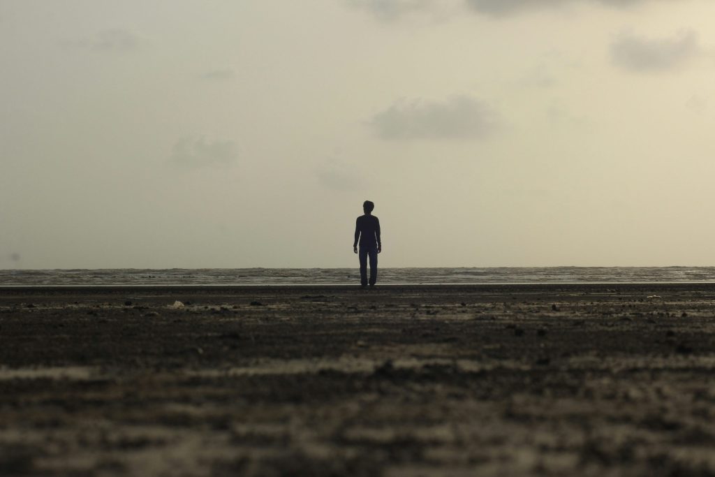 Silhouette of a man standing on seashore