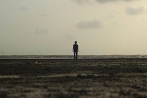 Silhouette of a man standing on seashore